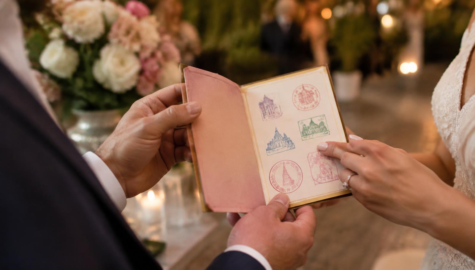 Couple holding their Wedding Experience Passport with collected stamps